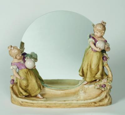 Appraisal: A ROYAL DUX FIGURAL PORCELAIN MIRROR STAND modelled as two