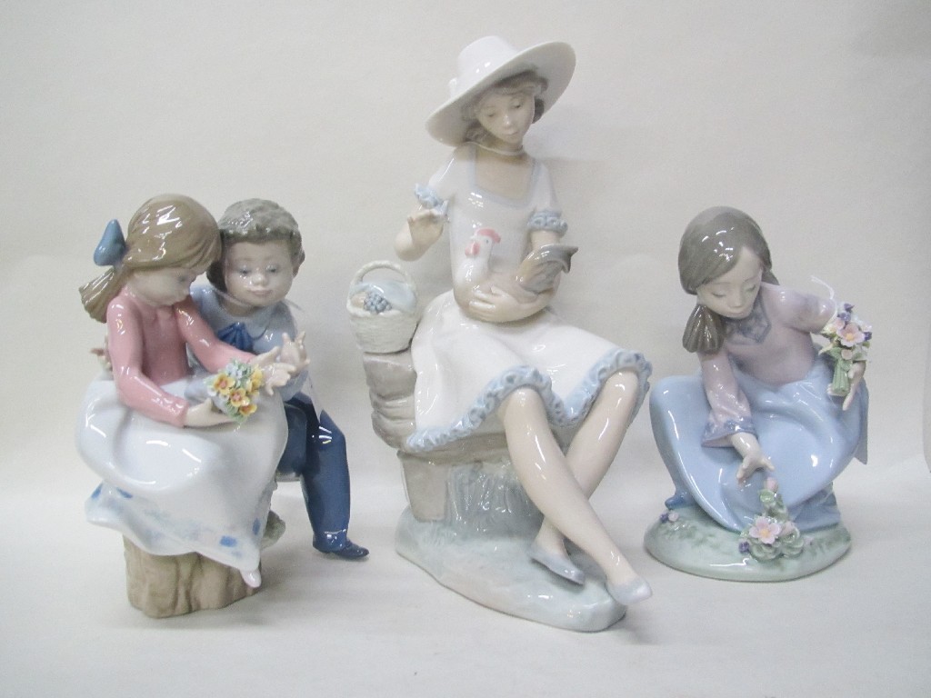 Appraisal: Two Lladro groups of children and a Nao figure of