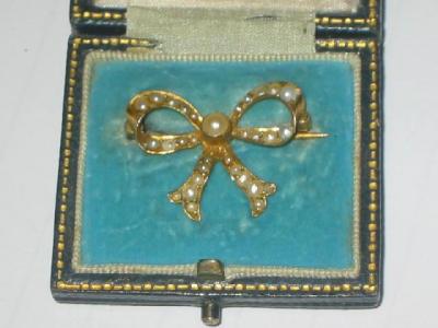 Appraisal: A VICTORIAN PEARL BROOCH modelled as a bow in yellow