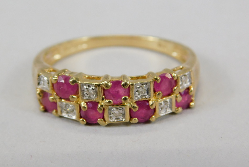 Appraisal: A ct gold dress ring set with garnet and white