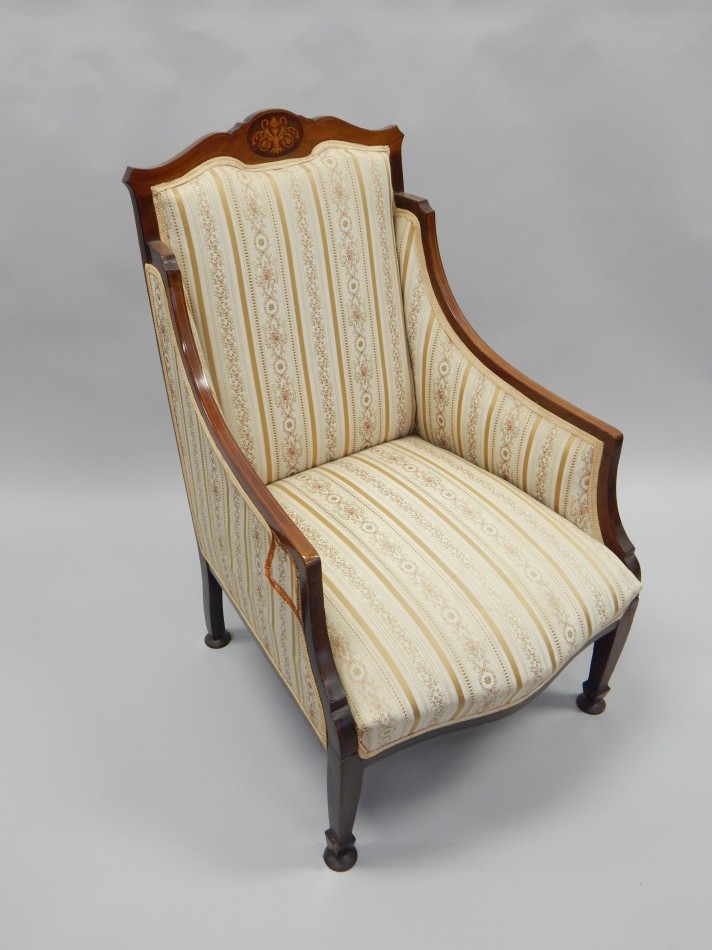 Appraisal: An Edwardian mahogany and marquetry armchair with padded back sides