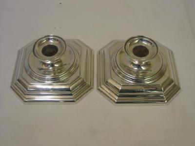 Appraisal: A PAIR OF CANDLESTICKS the moulded circular nozzle on low