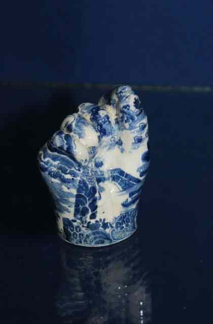 Appraisal: A TH CENTURY BLUE AND WHITE POTTERY STIRRUP CUP modelled