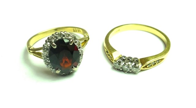 Appraisal: A gold garnet and diamond set oval cluster ring claw