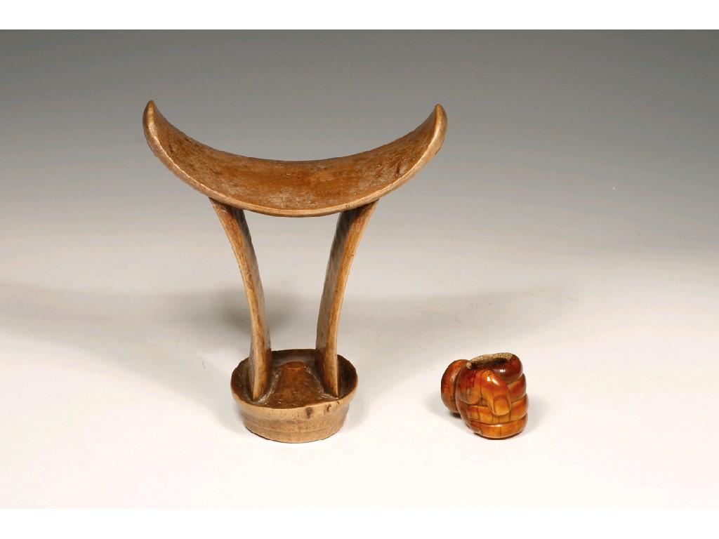 Appraisal: A TRIBAL CARVED WOOD HEAD REST with carved decoration high