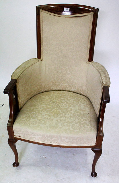 Appraisal: A WALNUT FRET CARVED ARM TUB CHAIR with cream upholstery