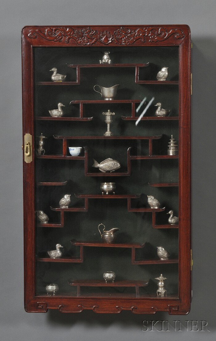 Appraisal: Rosewood Display Cabinet China th century together with twenty-three silver