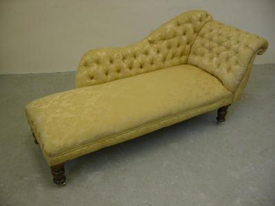 Appraisal: A VICTORIAN WALNUT FRAMED CHAISE LONGUE button upholstered in yellow