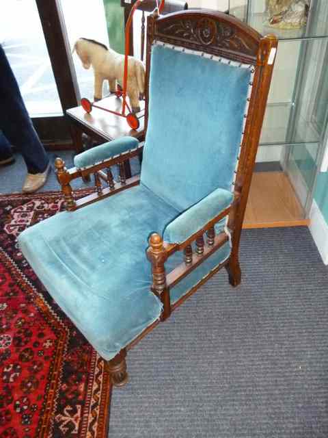 Appraisal: A VICTORIAN OAK LOW OPEN ARMCHAIR with carved cresting rail