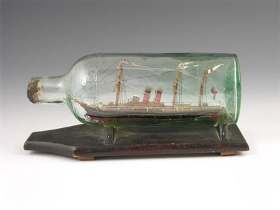 Appraisal: A model steam ship in a bottle on an ebonised