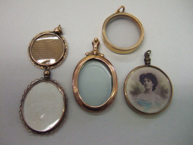 Appraisal: A gold mounted circular glazed pendant locket two further circular