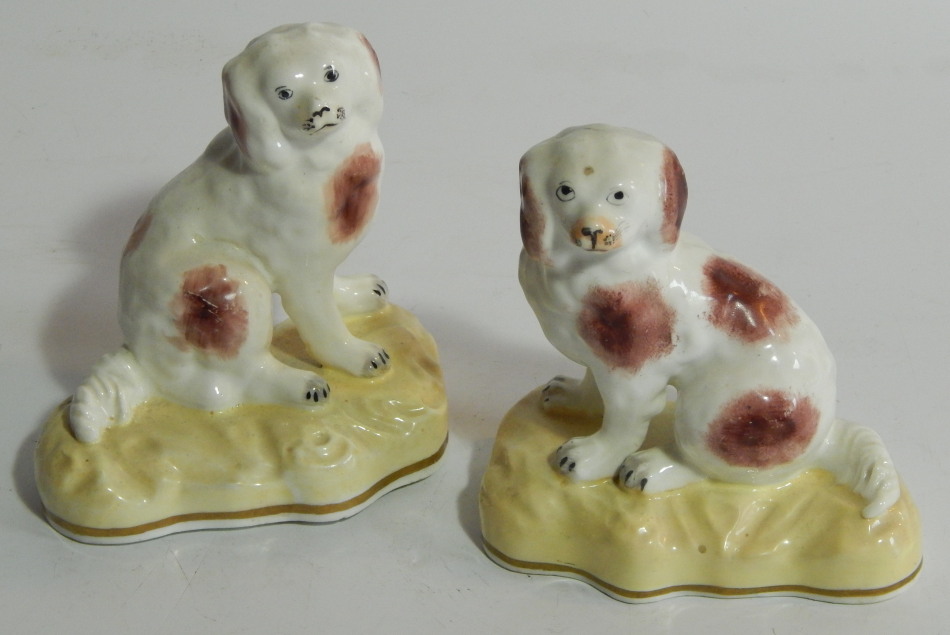 Appraisal: A pair of thC Staffordshire porcelain figures of spaniels modelled