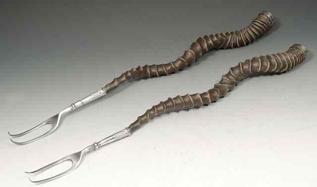 Appraisal: A PAIR OF TOASTING FORKS with metal mounts of gazelle