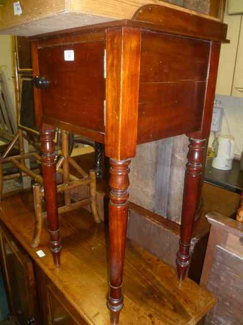 Appraisal: A VICTORIAN MAHOGANY POT CUPBOARD enclosed by single door on