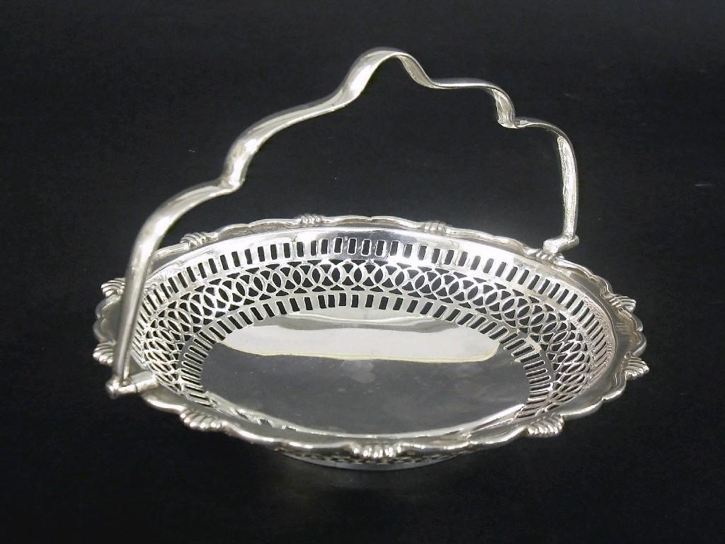 Appraisal: Early th century wavy rimmed basket with hinged serpentine handle