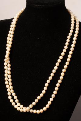 Appraisal: A two-row cultured pearl necklace with gold clasp modelled as