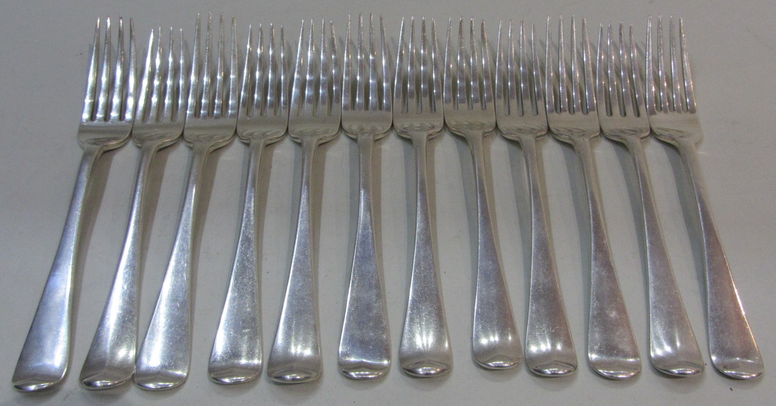 Appraisal: Twelve silver Old English pattern table forks all crest and