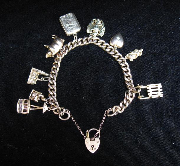 Appraisal: A CT YELLOW GOLD CURB LINK CHARM BRACELET with nine