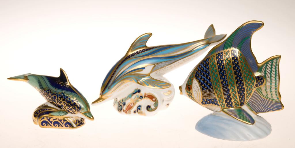 Appraisal: GROUP OF THREE ROYAL CROWN DERBY PAPERWEIGHTS comprising dolphin baby