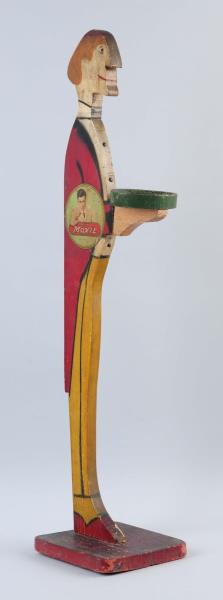 Appraisal: Wooden Moxie Butler Figure Wooden stand is slightly warped so