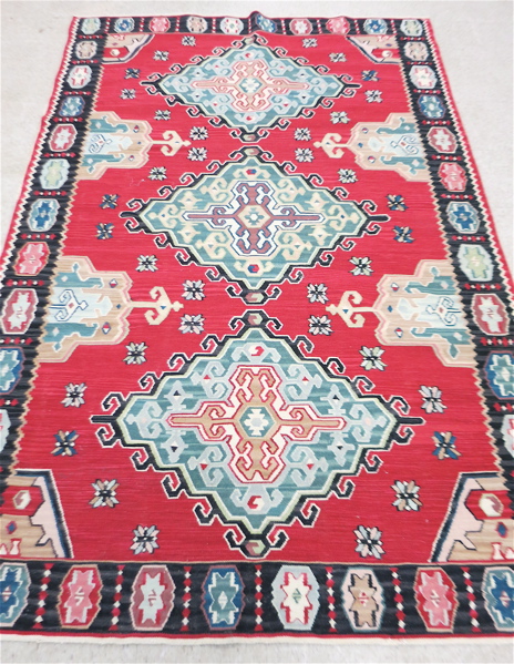 Appraisal: TURKISH FLATWEAVE KILIM AREA RUG triple medallion design on red