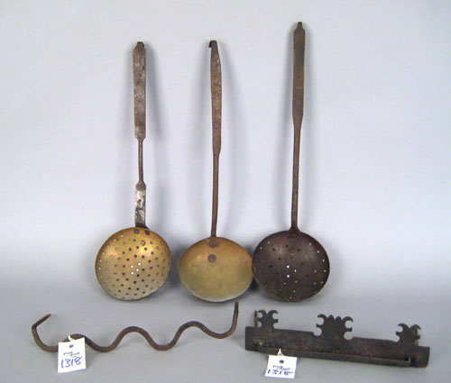 Appraisal: Two wrought iron strainers th c together with a ladle