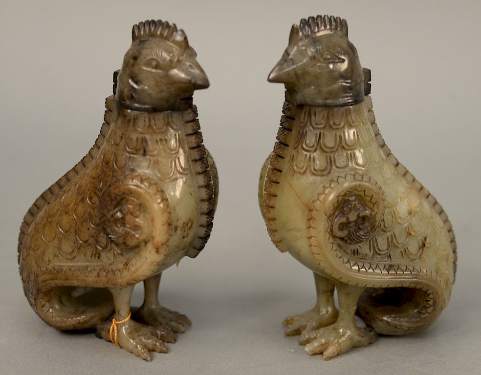 Appraisal: A pair of celadon and russet jade archaistic bird from