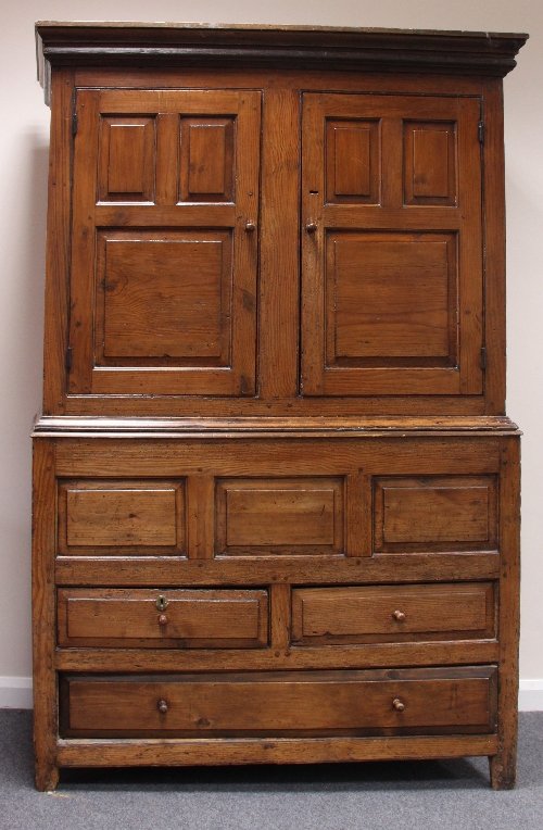 Appraisal: A Welsh pine cupboard with panelled doors and drawer beneath