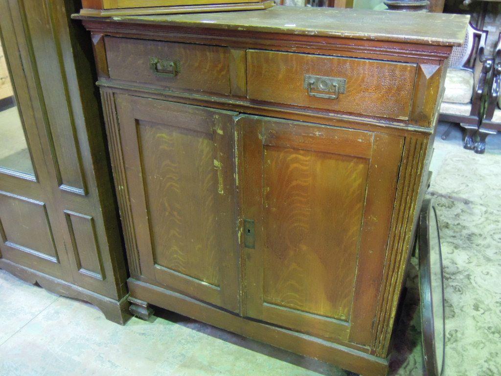 Appraisal: A stained pine side cupboard enclosed by a pair of