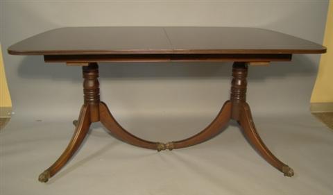 Appraisal: REGENCY STYLE TWO PEDESTAL MAHOGANY DINING TABLE having three leaves