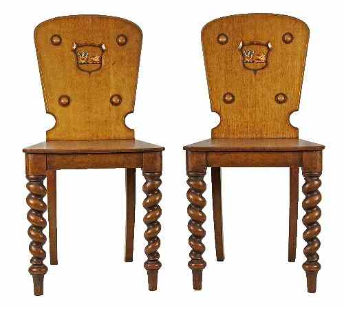 Appraisal: A pair of late Victorian pale oak hall chairs the