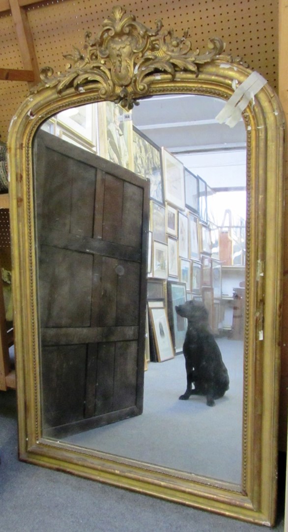 Appraisal: A th century arch top gilt framed overmantel mirror with