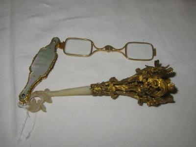 Appraisal: A PAIR OF GILDED METAL LORGNETTES with mother of pearl