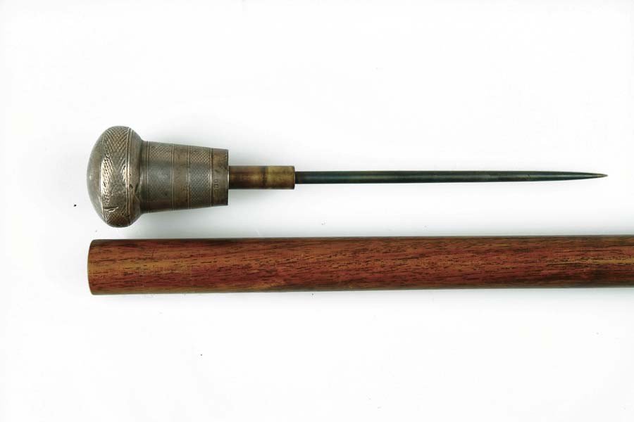 Appraisal: DAGGER CANE Hallmarked silver top pulls out from a mahogany