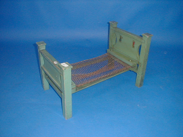 Appraisal: A green painted dolls bed with wire base