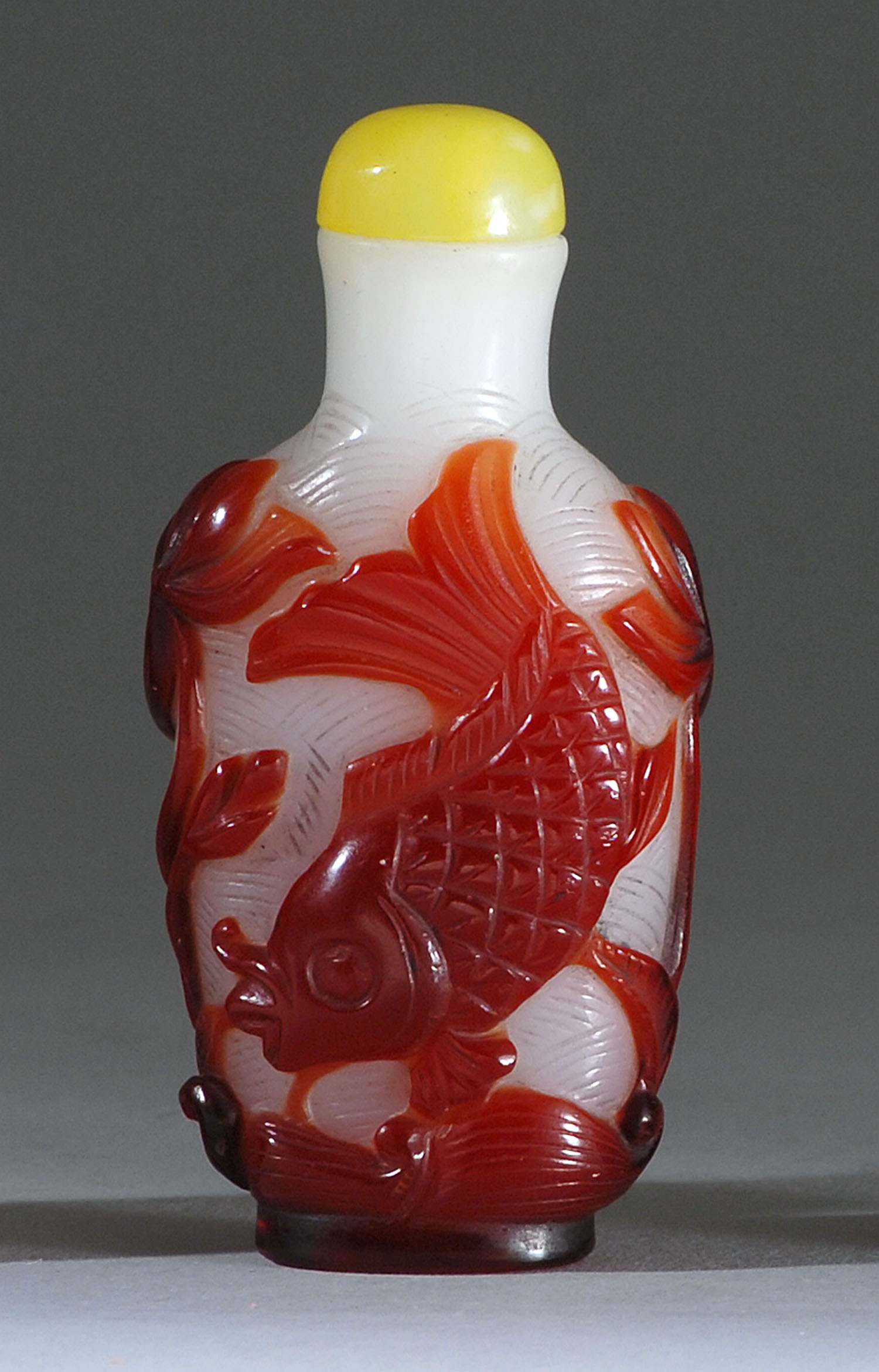 Appraisal: OVERLAY GLASS SNUFF BOTTLE Circa With red carp and lotus