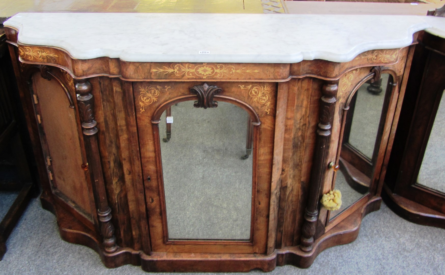 Appraisal: A Victorian figured walnut marble topped three door credenza on