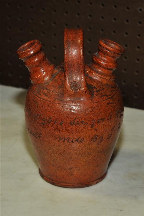 Appraisal: POTTERY WEDDING JUG Orange mottled and shiny glaze single handle