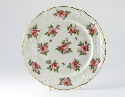 Appraisal: A Nantgarw plate with moulded rim painted with pink roses