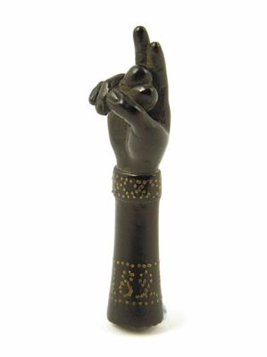 Appraisal: A Regency ebonised treen and pique work pipe tamper dated