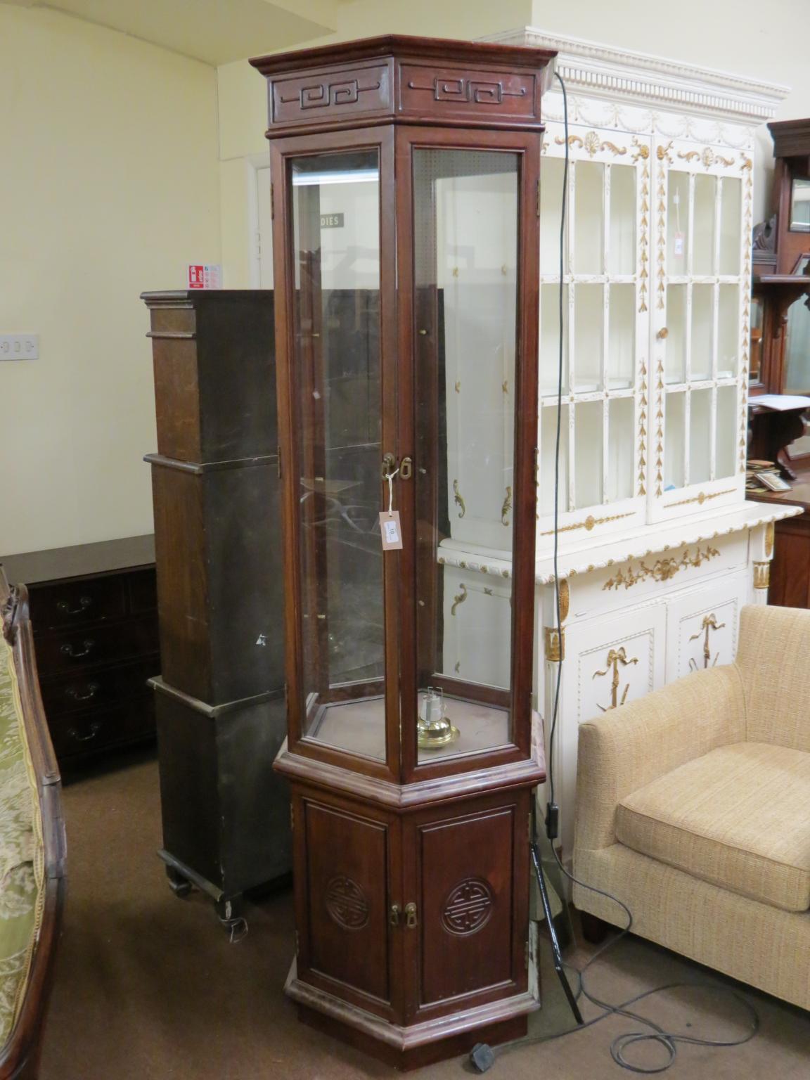 Appraisal: A Chinese rosewood display cabinet tall hexagonal-shape with three enclosed