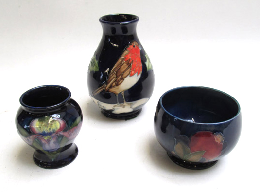 Appraisal: THREE MOORCROFT POTTERY VESSELS hand painted under glaze vase with