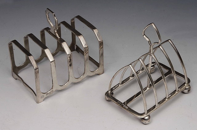 Appraisal: Two silver four divisional toast racksof stylised form grams