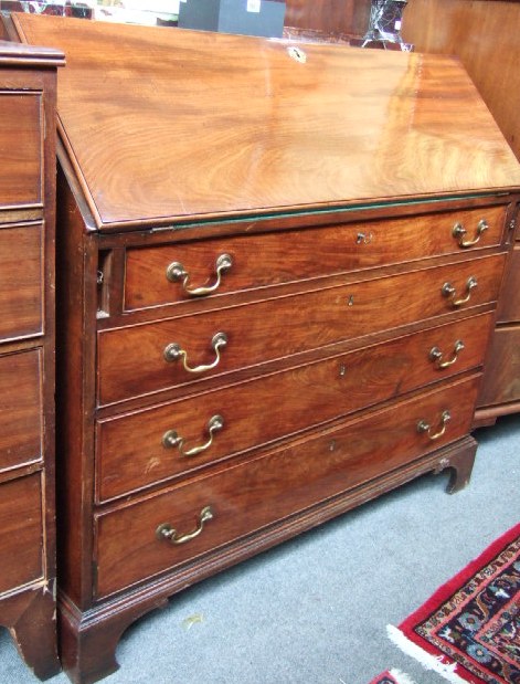 Appraisal: A George III mahogany bureau the fall enclosing a fitted