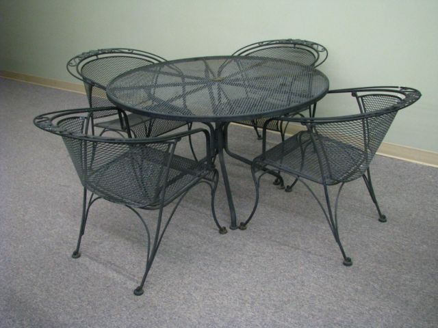 Appraisal: Wrought iron and metal mesh patio set inch round table