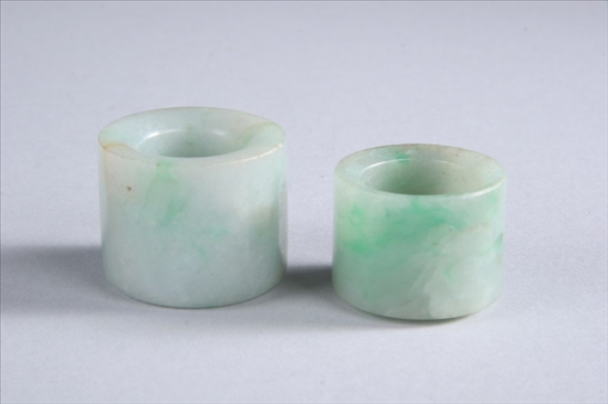 Appraisal: TWO CHINESE JADE ARCHER RINGS WITH APPLE GREEN INCLUSIONS Qing