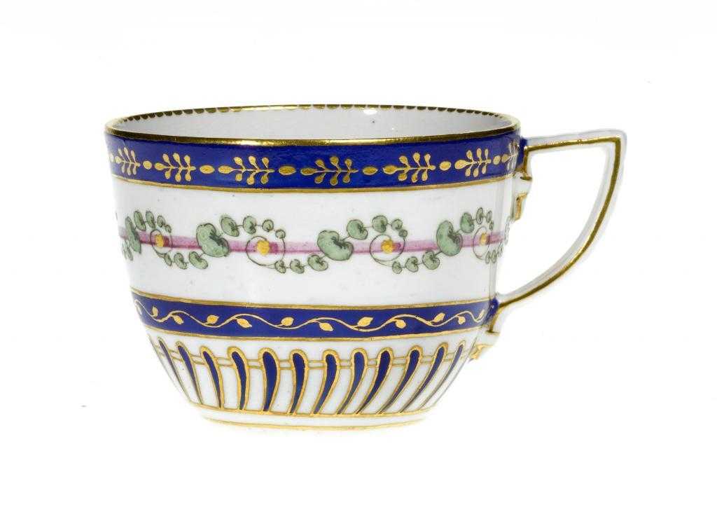 Appraisal: A CHELSEA-DERBY TEACUP enamelled in puce with a continuous tendril