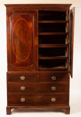 Appraisal: A George III mahogany linen press fitted sliding trays and