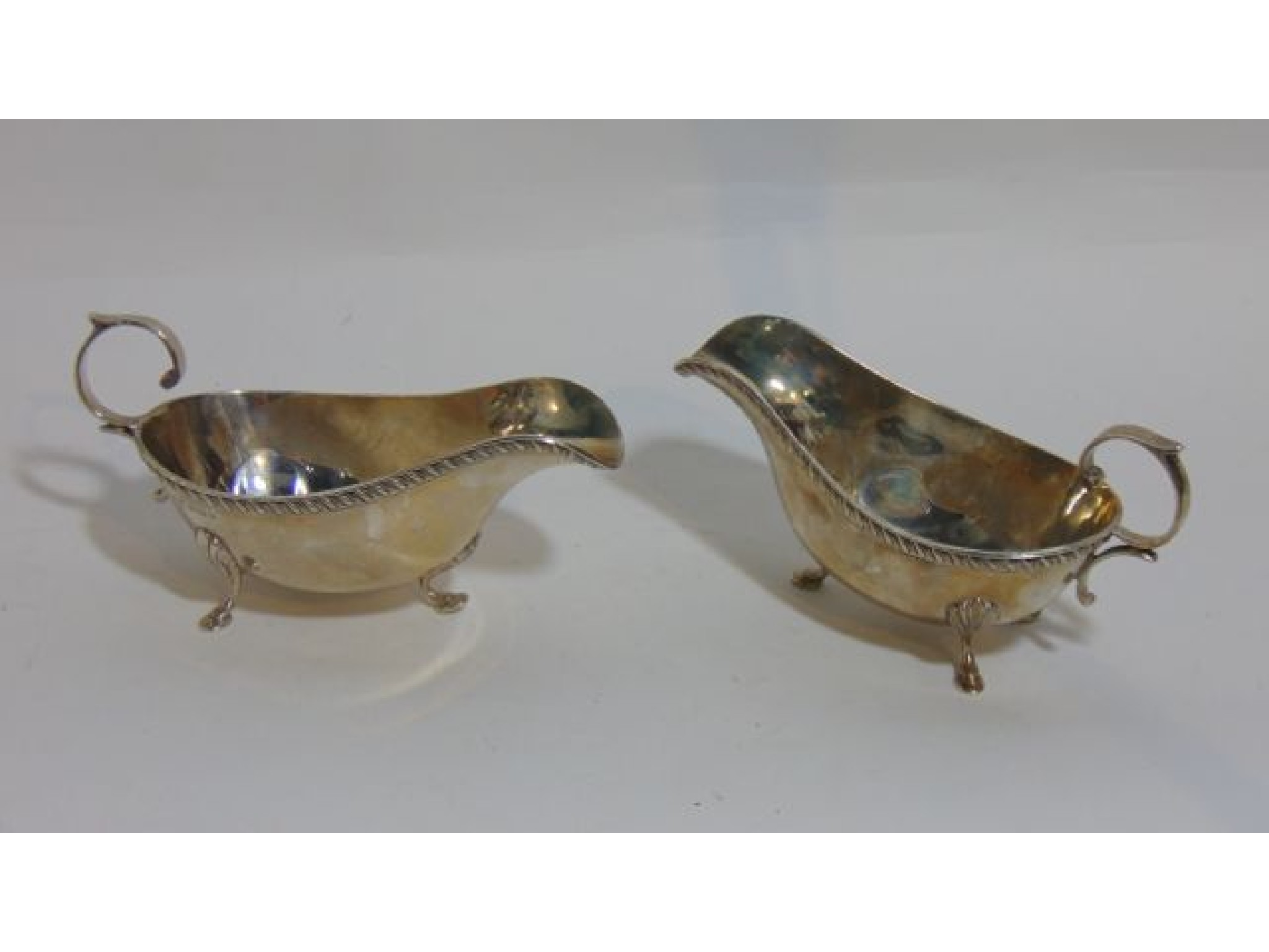 Appraisal: A pair of George V silver gravy boats Joseph Gloster