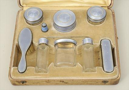 Appraisal: Enamel and Glass Dressing Set Comprising six lidded jars two